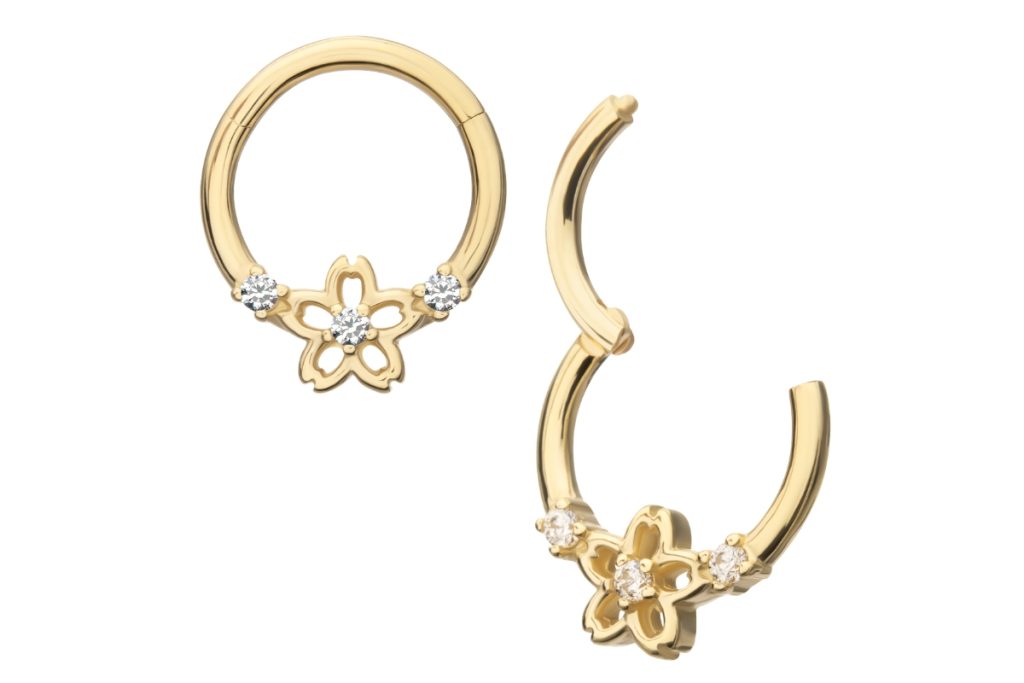 Gold hoop earrings with flower charm.