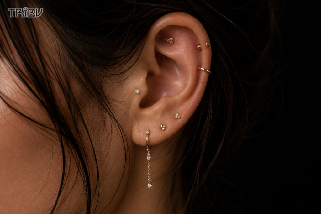 Curated ear piercings with gold stud earrings
